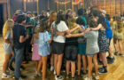 campers group hug in rec hall