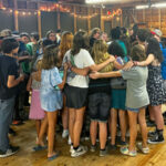 campers group hug in rec hall