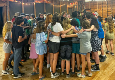 campers group hug in rec hall