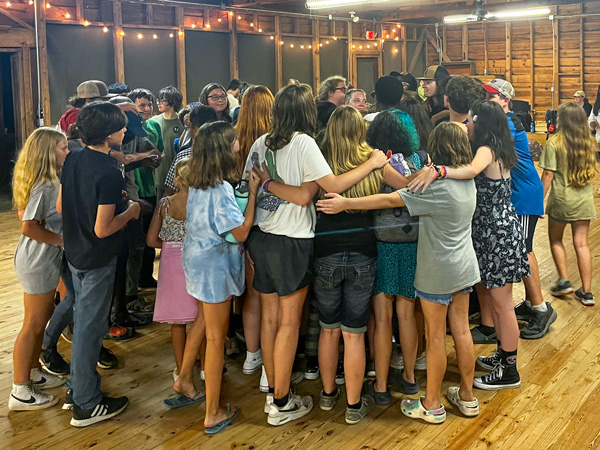 campers group hug in rec hall