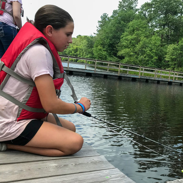 girl fishing on the dock