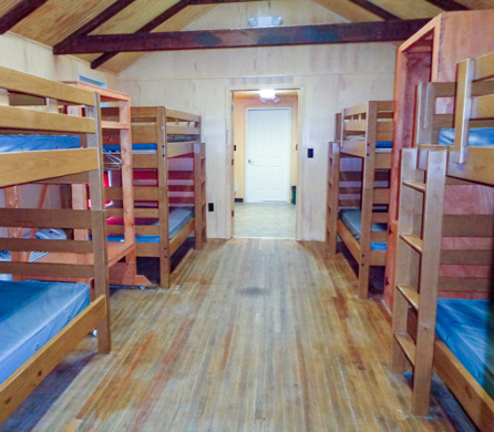 cabin showing bunk beds and the door to the bathroom