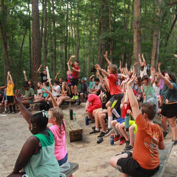 group cheering around campfire